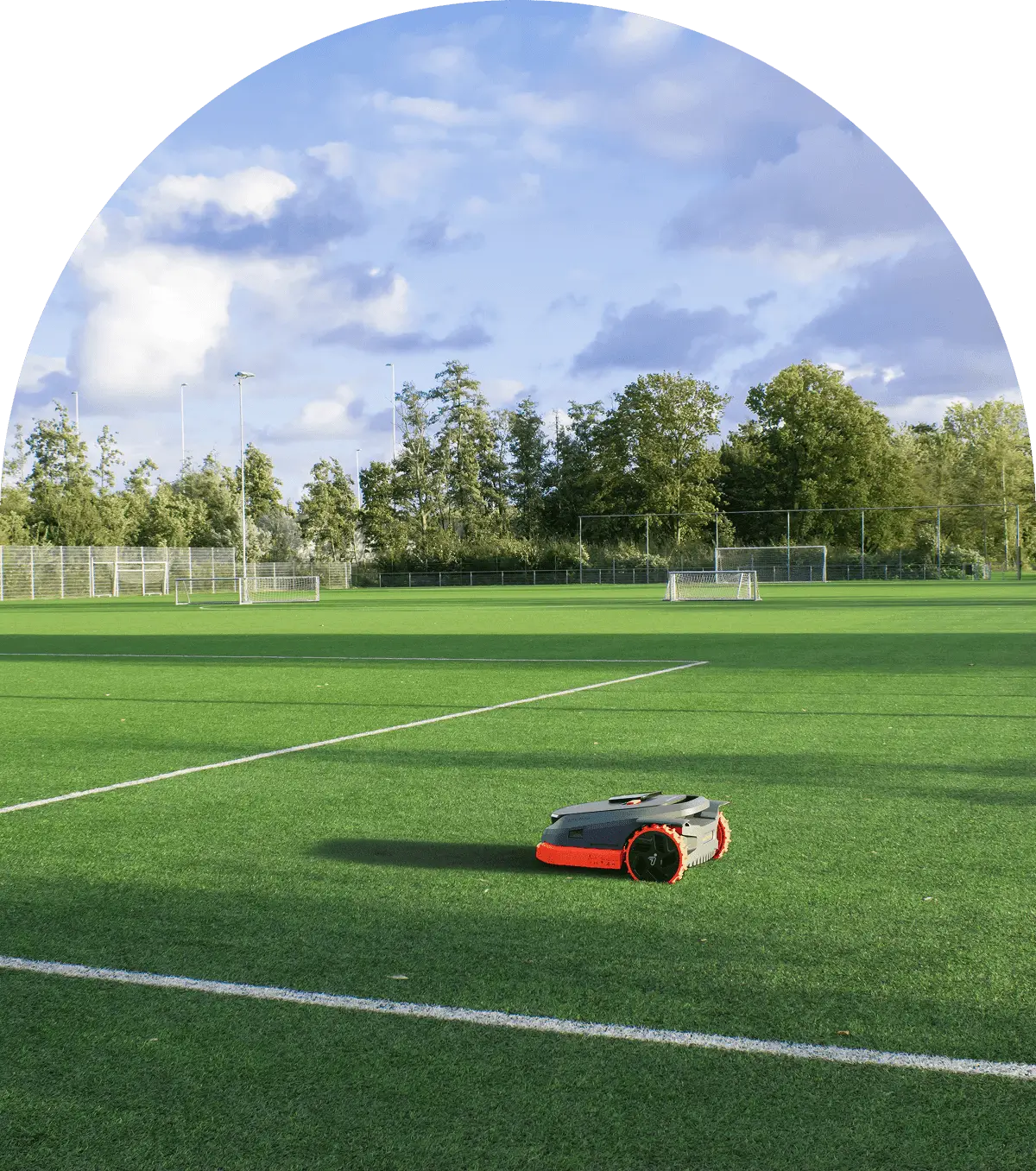 A robot mower cutting grass on a soccer field.